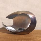Small Pebble shaped tea light holder with cut away design.